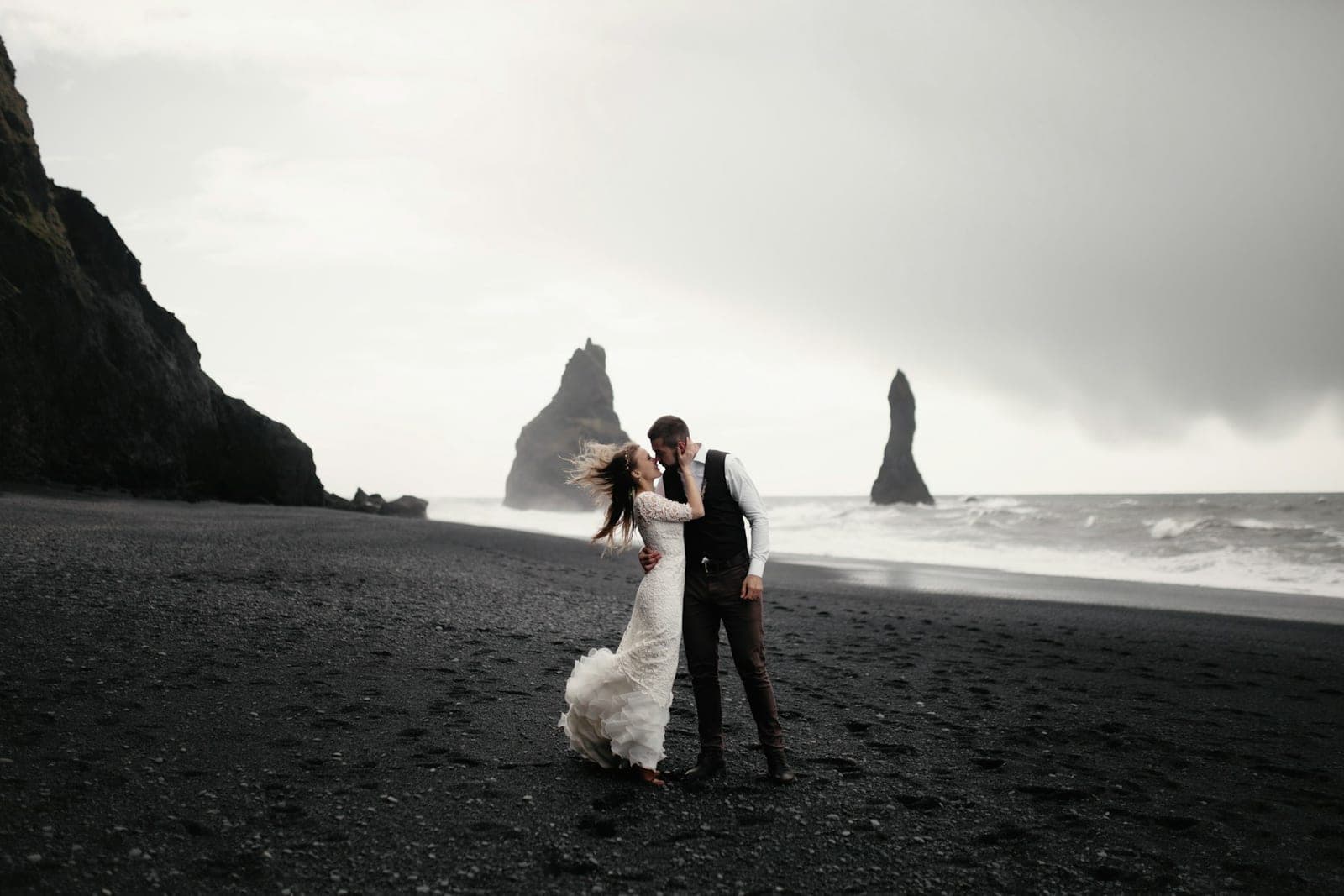 Walking the black sand at low tide