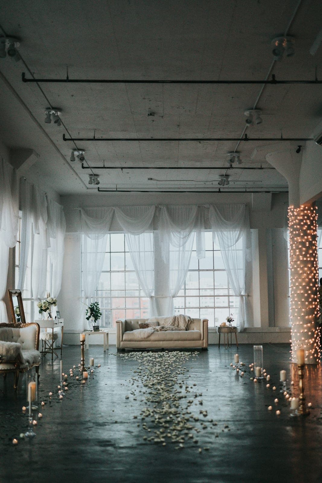 A bare-brick hall strung with lights