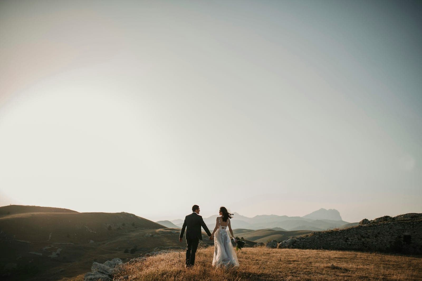 Walking together across open hills at sunset